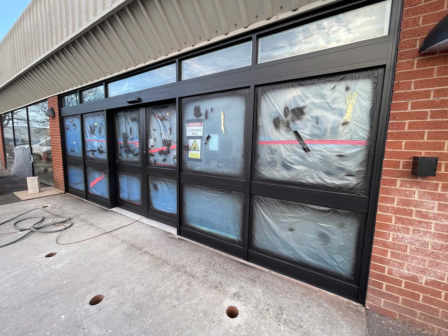 shop front spraying porcelanosa Chester large commercial unit painted black by sprayon.co.uk